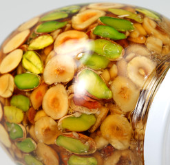 Nuts in honey in glass