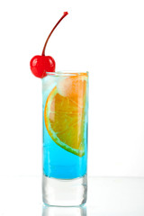 Alcohol cocktail with blue curacao, orange and maraschino