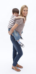 Fototapeta premium Mother giving son piggyback ride