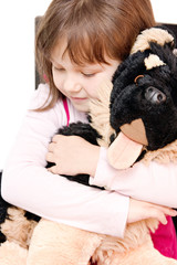 little girl hugging stuffed dog isolated on white