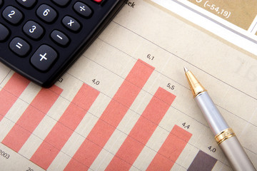 Overhead shot of a pen highlighting numbers on a financial statement