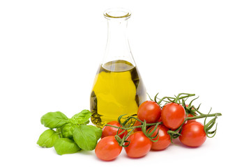 bottle of olive oi, tomatoes and basil isolated on white backgro