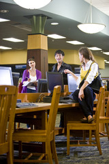 College students hanging out by library computers