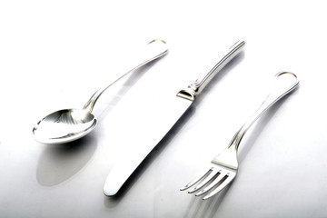 Flat lay of metallic cutlery spoon, fork, knife 
