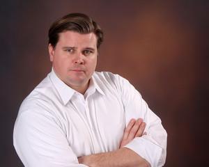 Businessman in shirtsleeves with a stern expression