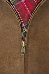 unzipped brass zipper of leather jacket