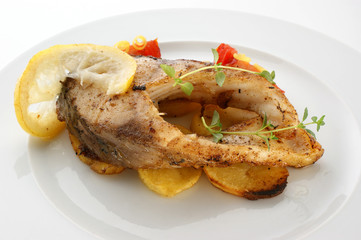 carp fillet on organic potato and lemon