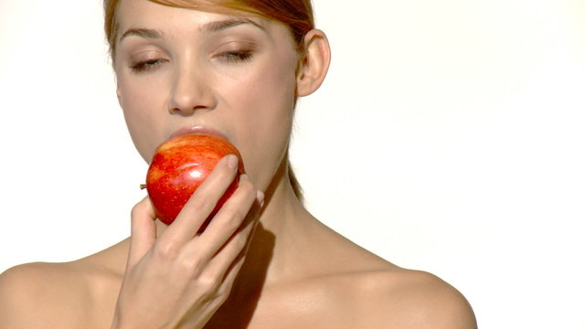 Portrait of beautiful and sexy woman eating red apple