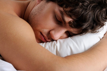 Fototapeta na wymiar Close-up pretty face of sleeping man