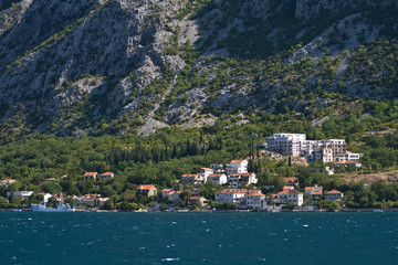 Fototapeta na wymiar Settlement at the foot of mountain, Bay of Kotor, Montenegro