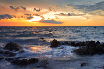 Obraz premium Tropical sunset on the stones beach. Lanta island. Thailand