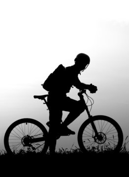 adventure cycling in the nature - mountain biker silhouette