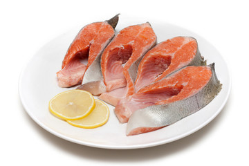 Red fish bit with lemon on plate