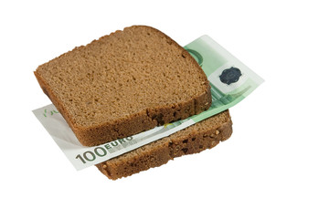 One-hundred euro bill between two slices of brown bread