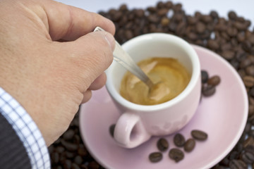 Cup of coffee sitting in a bed of coffee beans