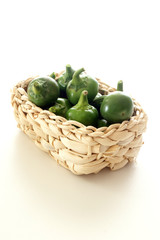 organic green and red cherry paprika in a basket