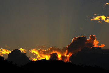 sunset lights through the clouds