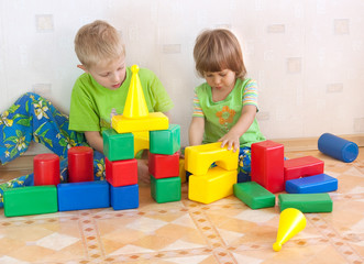 Children build a tower of cubes