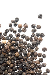 Close up of black peppercorns in isolated white background