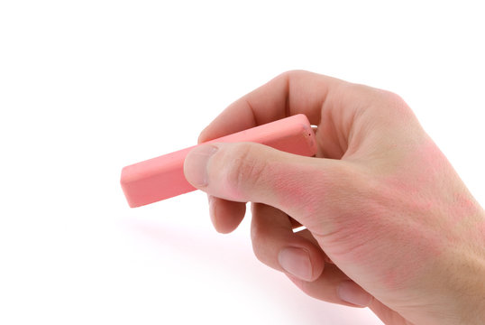 Hand With Pink Chalk Writing On A White Background