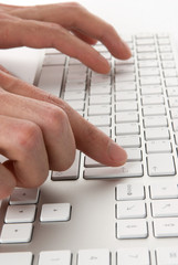 male fingers pressing computer keys at workplace