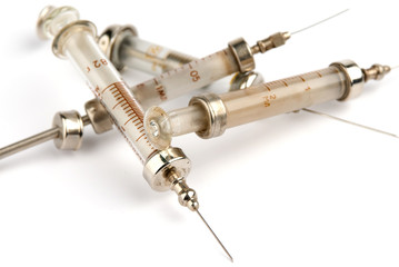 pile of old syringes on white background