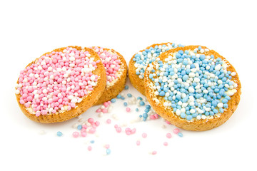 Rusk with blue and pink mice over white background