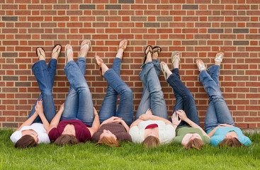 Group of College Girls at School With Legs up on Wall