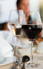 The served table with red wine at restaurant (shallow dof)