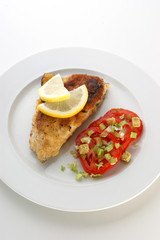 Fototapeta na wymiar deep fried fish and lemon, organic tomato