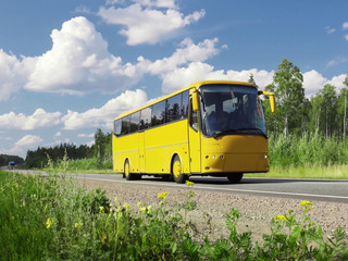 yellow tourist bus on highway and rural landscape