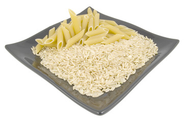 pasta and rice on black plate isolated on white background