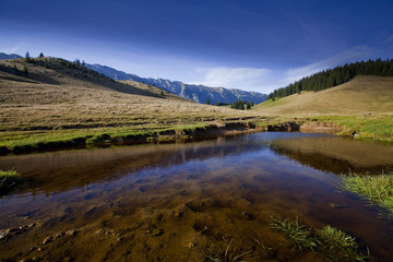 Beautiful autumn scenery in the mountains with lake reflection