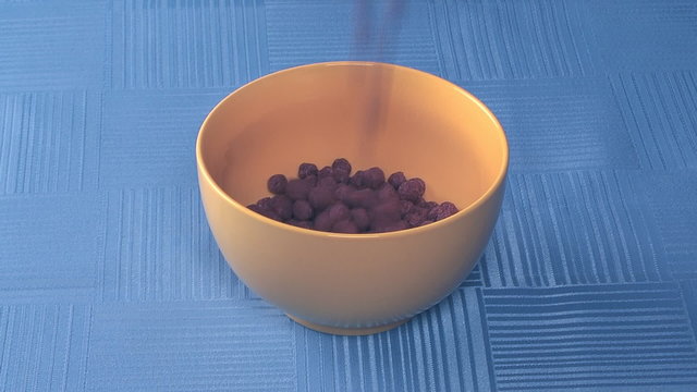 To fill chocolate corn-flakes in a yellow cup.