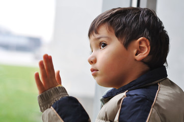 A kid on the window waiting