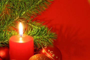 chrismas still life with red candles and bolls
