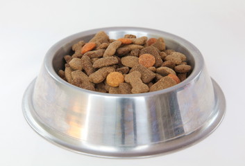 Silver bowl with dry dog food
