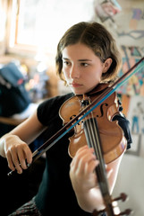 Pretty Young Woman Practicing Violin © forestpath