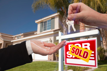 Handing Over the House Keys in Front of New Home