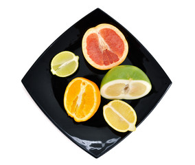 Halved citrus fruits on the plate (top)