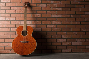 Fototapeta na wymiar Classic Guitar About a Brick Wall