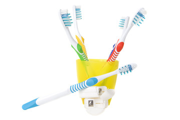 Five colorful toothbrushes and dental floss