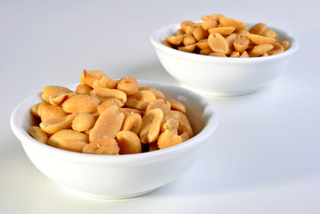 roasted salted peanuts in a white bowl