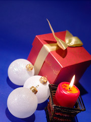 Christmas background with candle and decorations on blue