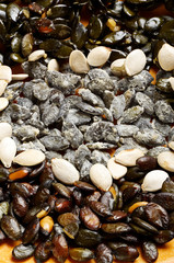 Raw and fried prepared different pumpkin seeds