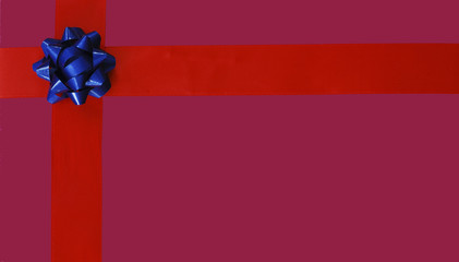 Illustration of blue Christmas bow and red ribbon