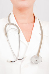 Young optimistic female doctor in uniform with stethoscope