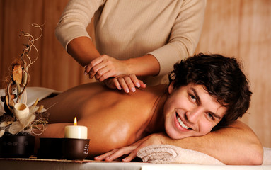 Obraz na płótnie Canvas handsome happy young man on massage