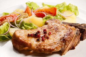 Grilled meat with boiled potatoes and vegetable salad