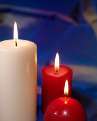 Fototapeta na wymiar Burning candles on blue background